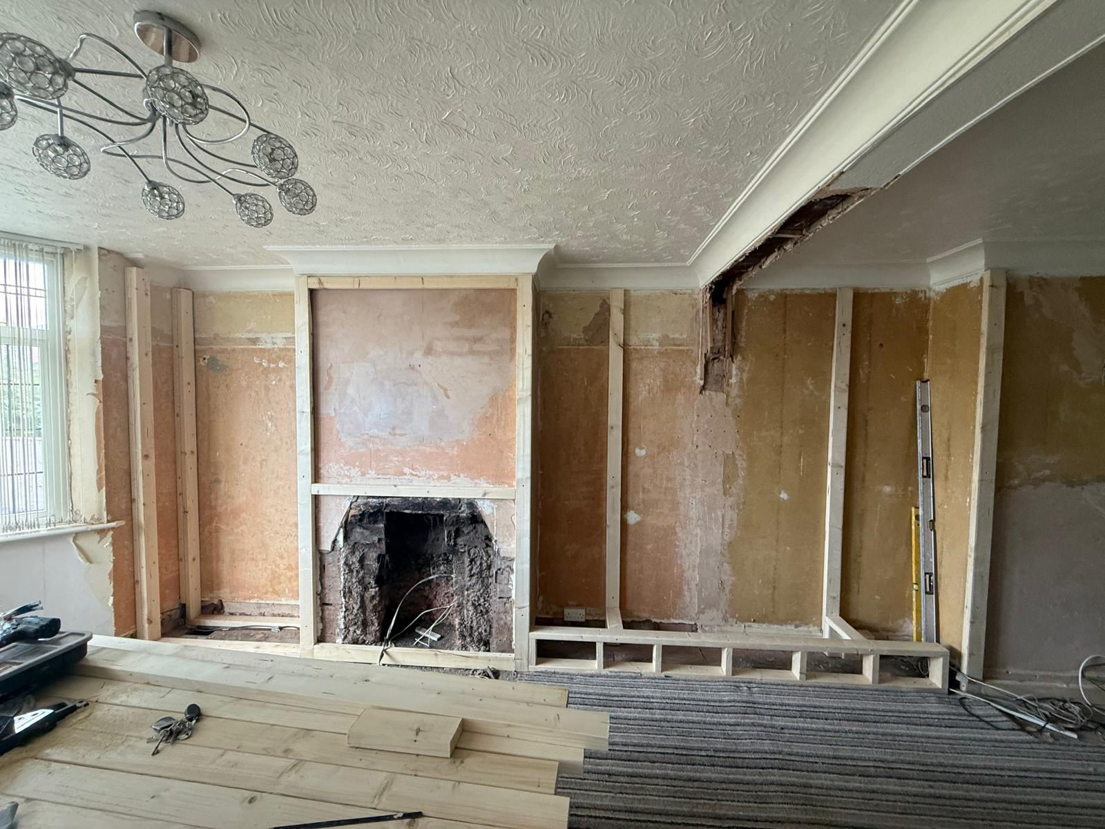 Timber framing built around the original fireplace opening in the lounge