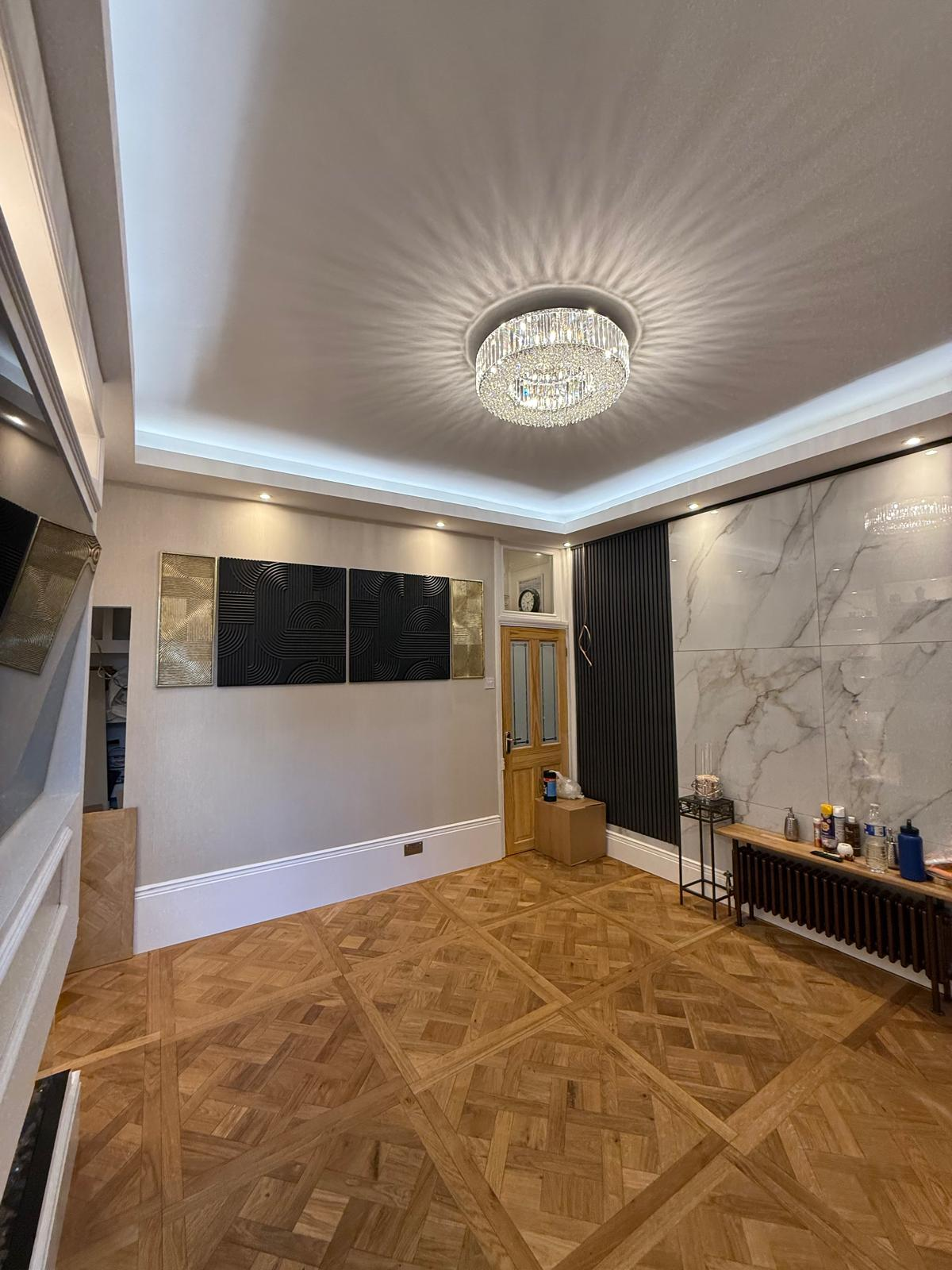 Completed interior with patterned timber floor, crystal chandelier and marble feature wall