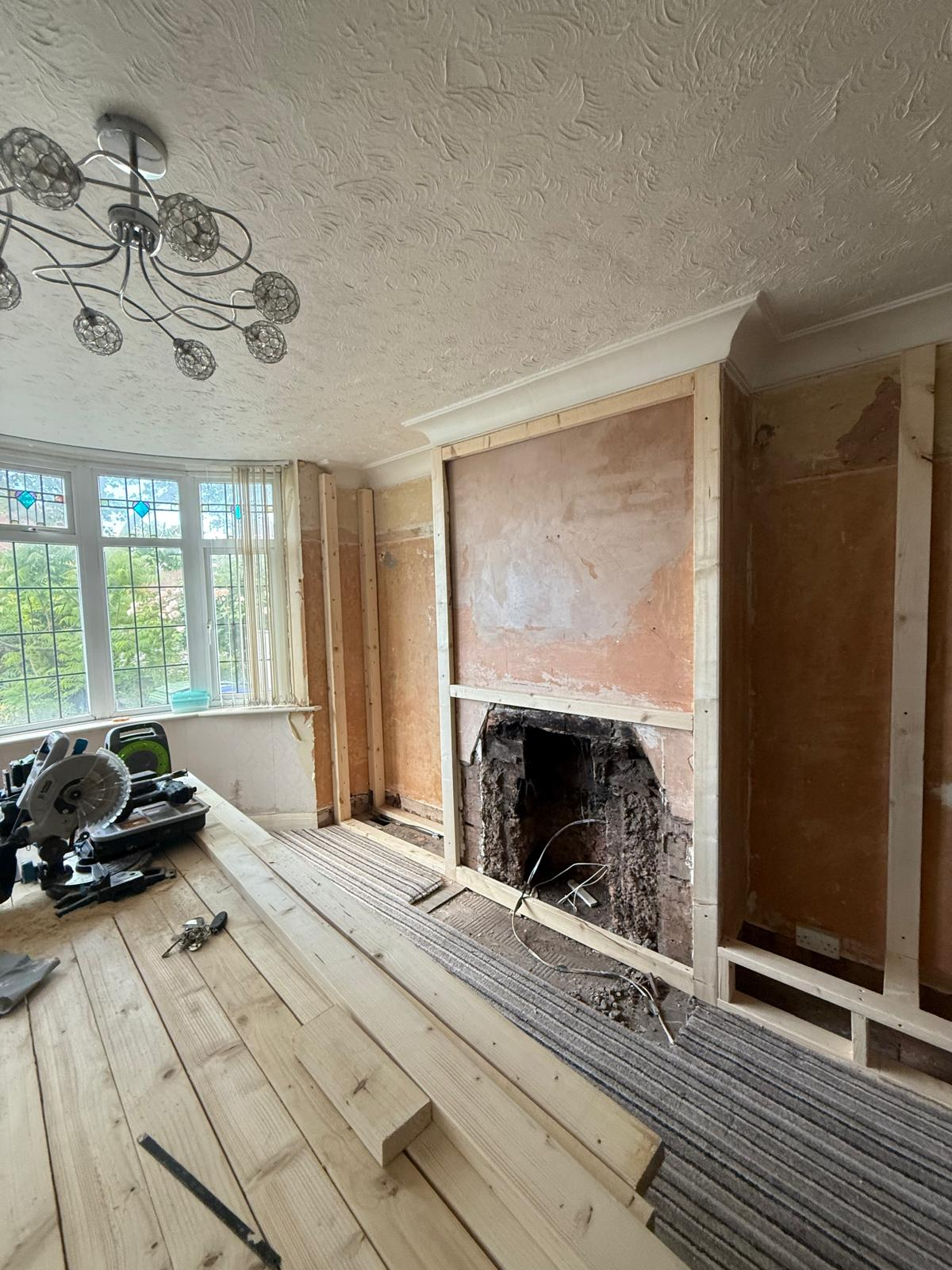 Lounge bay window area with new timber framing and flooring boards laid out