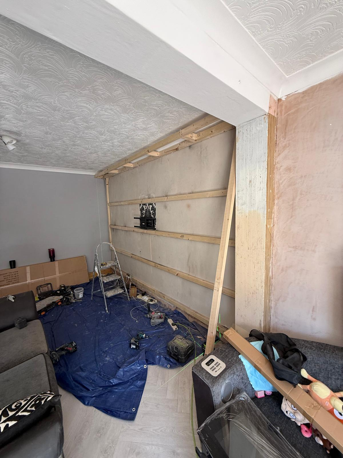 Timber batten framing set out across a lounge wall ready for slat panelling
