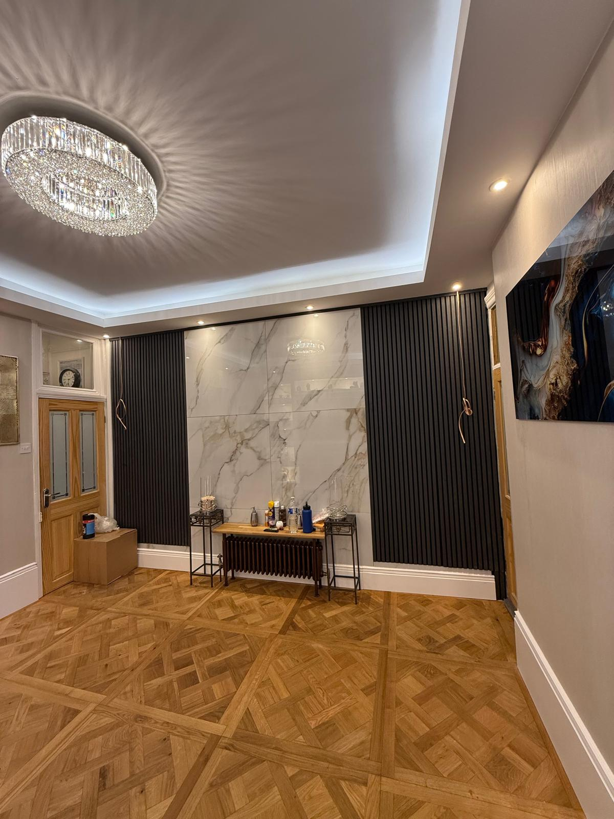 Finished feature wall with marble centre panels and dark fluted detailing