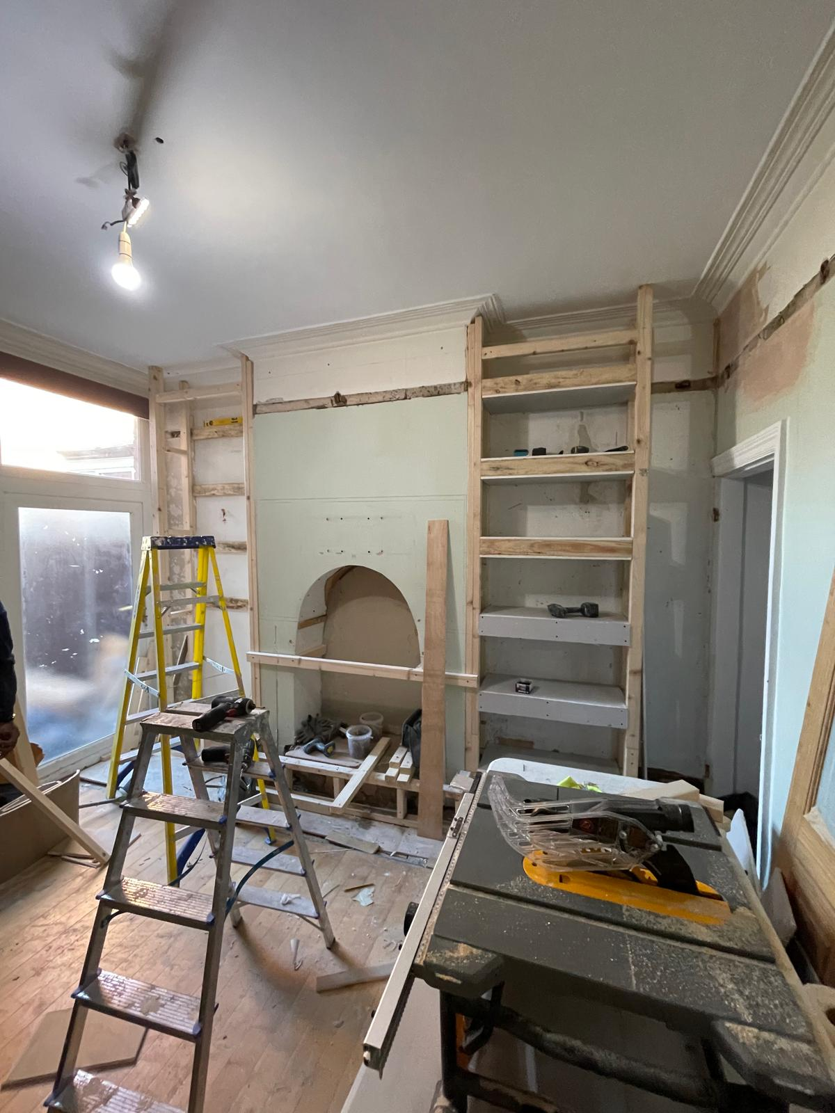 Timber framing being built around a fireplace for a bespoke media wall