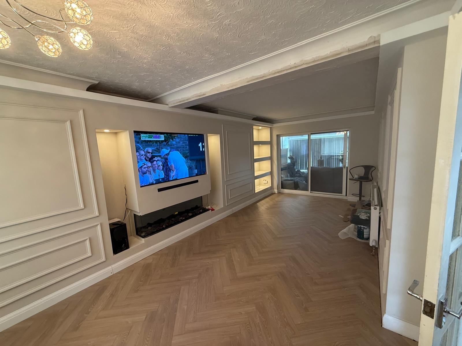 Completed lounge with media wall, panelled walls and herringbone flooring