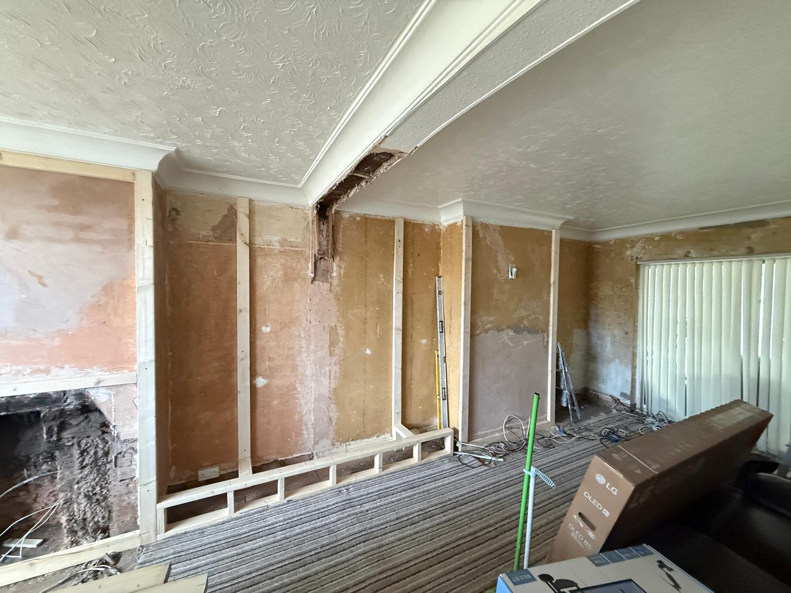 Lounge walls stripped back with timber studwork formed for new alcoves