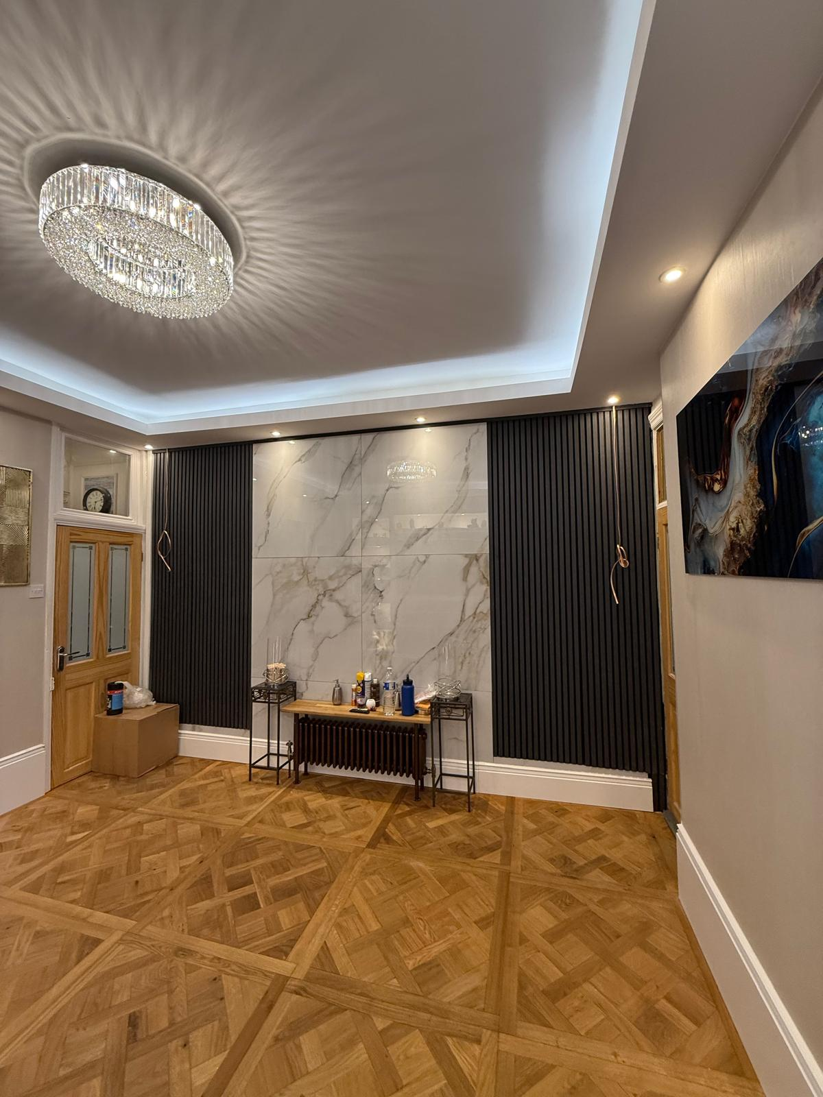 Finished marble panel wall with dark vertical slats and warm interior lighting
