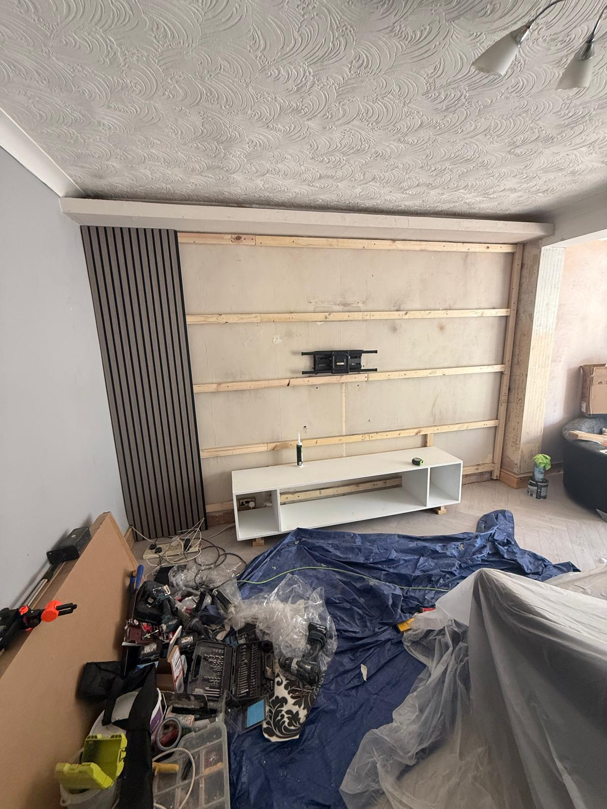Battened wall with TV bracket mounted and first slat panel section fitted