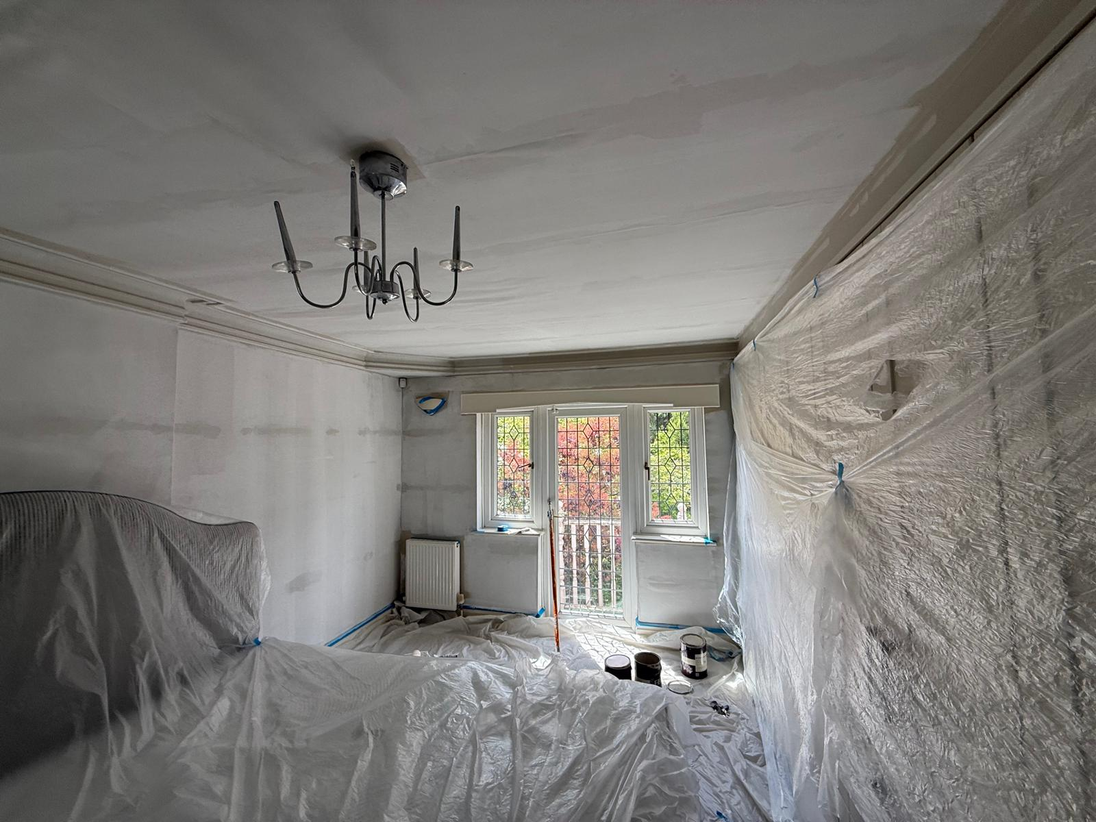 Bedroom prepared and protected with dust sheets prior to redecoration